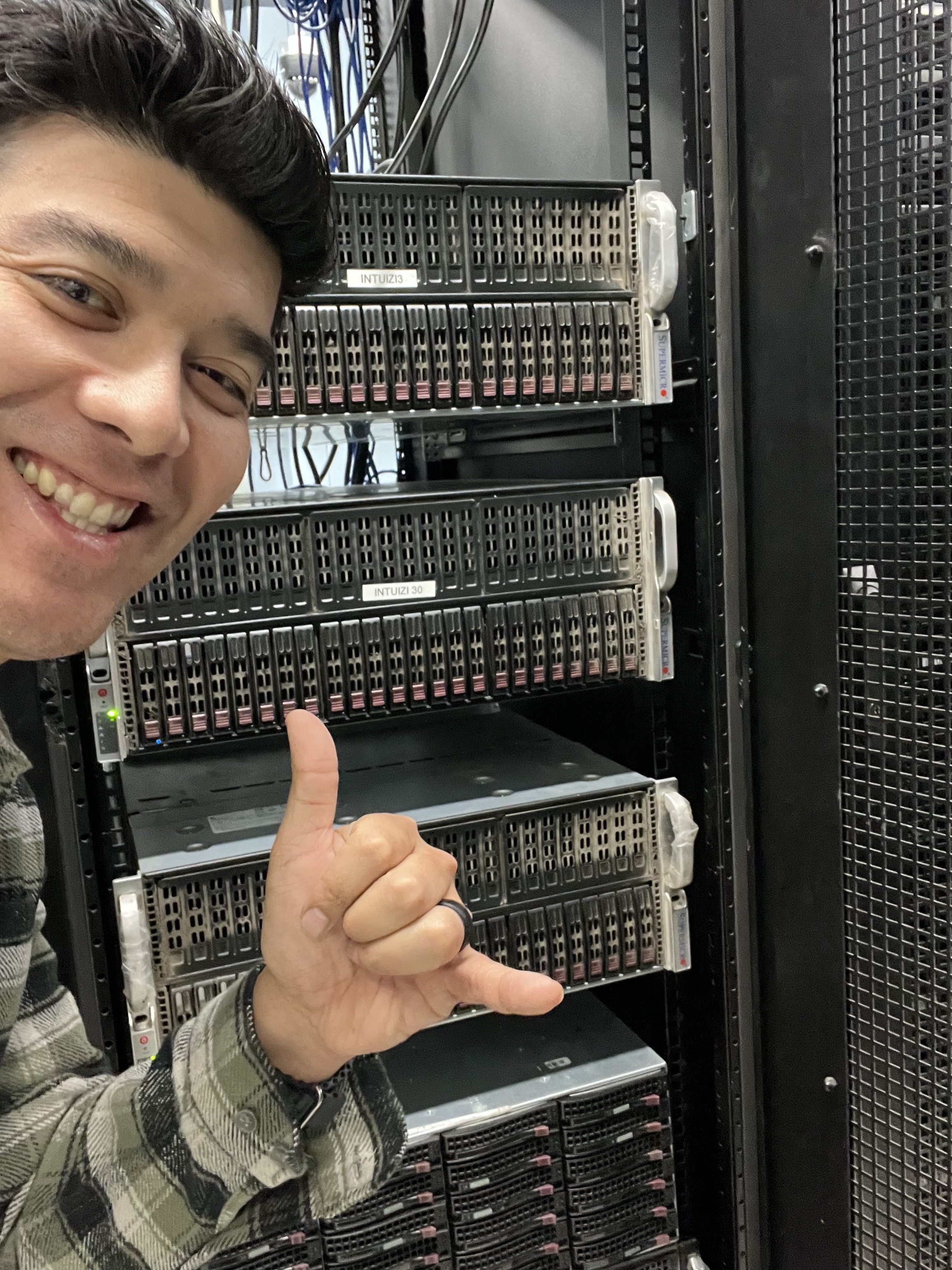 A team member beside Intuizi server racks